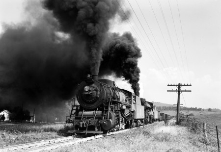 Lehigh and New England steam locomotives double-heading to pull twenty-one cars of a freight train east up the steep grade to Summit, Pennsylvania, on September 1, 1946. Leading the charge is 303, a 2-8-0 of the E-14 class, followed by 2-10-0 F-1 403. Photograph by Donald W. Furler, Furler-02-035-01, © 2017, Center for Railroad Photography and Art