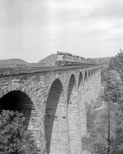 Erie Lackawanna Railway diesel locomotive no. 3660 leads a westbound freight train across the Starrucca Viaduct at Lanesboro, Pennsylvania, October 5th 1975; Photograph by Victor Hand. Hand-EL-30-188
