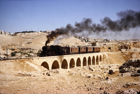 Hedjaz Jordan Railway 2-8-2 steam locomotive no. 51 crosses a bridge in Amman, Jordan, on July 17, 1991. Photograph by Fred M. Springer, © 2014, Center for Railroad Photography and Art. Springer-Hedjaz-ZimZam(1)-05-13