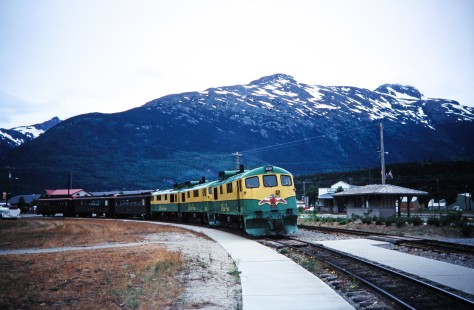 White Pass and Yukon Route diesel locomotive no. 97 and passenger train pull up to the platform in Skagway, Alaska, United States, on June 14, 1998. Photograph by Fred M. Springer, © 2014, Center for Railroad Photography and Art. Springer-Alaska-NZ-12-01