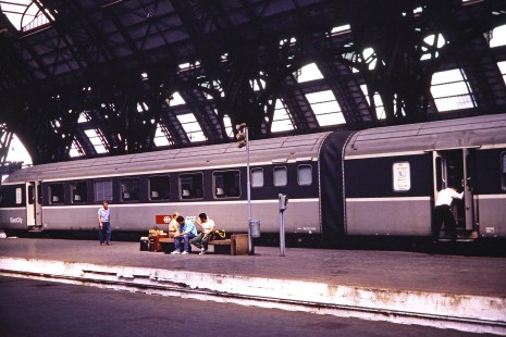 Passengers wait on a bench near a Eurocity train in Milan, Lombardy, Italy, on July 9, 1989. Photograph by Fred M. Springer, © 2014, Center for Railroad Photography and Art. Springer-Scan-Swiss-York-16-02