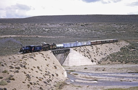 Viejo Expreso Patagónico (Old Patagonian Express) steam locomotives nos. 4 and 114 haul mixed freight and a passenger train near La Cancha, Chubut, Argentina, on October 30, 1995. Photograph by Fred M. Springer.  © 2014, Center for Railroad Photography and Art, Springer-CHI-ARG1-11-27