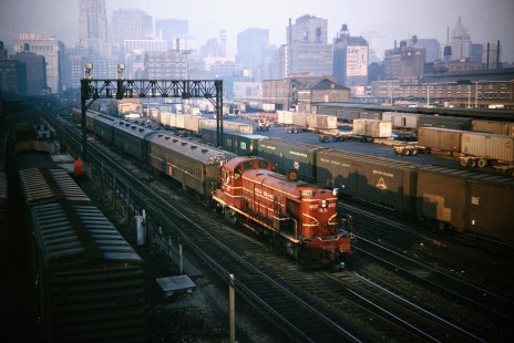 Chicago Rock Island and Pacific Railroad Alco diesel locomotive no. 487 with a commuter train leaving Chicago's LaSalle Street Station from Roosevelt Road bridge on Thursday, December 9, 1965. Photograph by Thomas F. McIlwraith, McIlwraith-01-002-08, © 2018, Center for Railroad Photography & Art, <a href="http://www.railphoto-art.org" rel="noreferrer nofollow">www.railphoto-art.org</a>