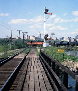 Milwaukee Road SD7 diesel locomotive no. 515 leading a local freight train across the Chicago & North Western Railway in in Madison, Wisconsin, on May 3, 1968. Both lines are on causeways in Lake Monona, and the Wisconsin State Capitol is visible in the distance. Photograph by Thomas F. McIlwraith, McIlwraith-01-016-16, © 2018, Center for Railroad Photography & Art, <a href="http://www.railphoto-art.org" rel="noreferrer nofollow">www.railphoto-art.org</a>