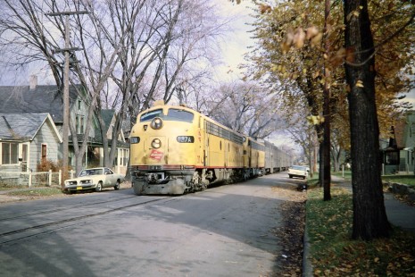 Milwaukee Road E9 diesel locomotives nos. 37A and 38A leading a football special passenger train from Milwaukee down East Wilson Street in Madison, Wisconsin, on November 9, 1968. The University of Wisconsin fell by a score of 43-8 to Ohio State. While the Badgers lost all of their games in 1968, the Buckeyes won all of theirs, beating the University of Southern California in the Rose Bowl to win the national championship. Photograph by Thomas F. McIlwraith, McIlwraith-01-025-04, © 2018, Center for Railroad Photography & Art, <a href="http://www.railphoto-art.org" rel="noreferrer nofollow">www.railphoto-art.org</a>