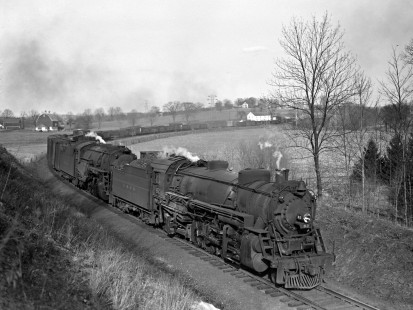Lehigh and Hudson River Railway steam locomotive nos. 82 and 90, a 2-8-2 and 2-8-0 respectively, move a freight train west through New Milford, New York, on March 28, 1943. Photograph by Donald W. Furler, Furler-01-050-01, © 2017, Center for Railroad Photography and Art