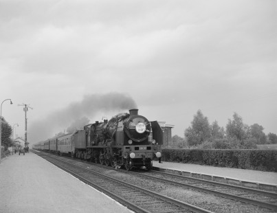 French National Railways steam locomotive no. 231-E37 pulling passenger train no. 82 named "Golden Arrow" running from Calais to Paris  Quend-Fort-Mahon-Plage, Somme, France, on July 6, 1963. Photograph by Victor Hand, Hand-SNCF-02-0216
