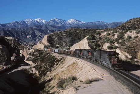 Southern Pacific Railroad locomotive no. 8355 hauls westbound freight at Cajon Pass Canyon in Hiland, California, on December 10, 1986. Photograph by William Botkin, BOTKINW-18-WT-90 © 1986, William Botkin.