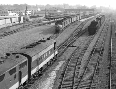 New highway bridge constructed in 1957 provided excellent views of Meridian's 22nd Avenue and opened up grand vistas of railroad passenger activity in the mid-town area. Here a Birmingham-bound Southern Railway train leaves the yard just as Mobile-bound Gulf, Mobile and Ohio Railroad <i>Gulf Coast Rebel</i> pulls away from the station in August 1957. Photograph by J. Parker Lamb, © 2016, Center for Railroad Photography and Art. Lamb-01-134-08