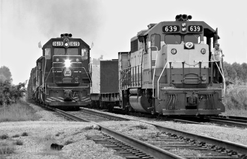 Seaboard Coast Line Railroad run-through freight train (extra) from Memphis, Tennessee, to Florida, passes Frisco local at Sulligent, Alabama, in August 1974. Photograph by J. Parker Lamb, © 2016, Center for Railroad Photography and Art. Lamb-02-003-08