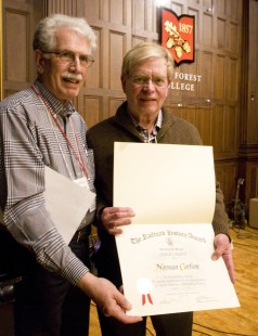 Ron Goldfeder stands with Norman Carlson as he displays award from Railway & Locomotive Society at Friday night dinner. Center for Railroad Photography and Art. Photograph by Henry A. Koshollek