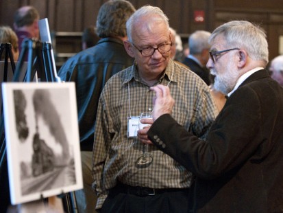 Kevin Haas (left) and anothe attendee talk at the Friday night social hour.
