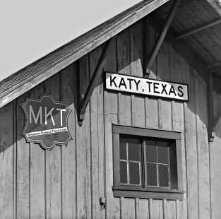 Newly installed metal sign on aging Missouri–Kansas–Texas Railroad wooden depot in Houston, Texas, suburb in June 1967. Photograph by J. Parker Lamb, © 2016, Center for Railroad Photography and Art. Lamb-02-042-01