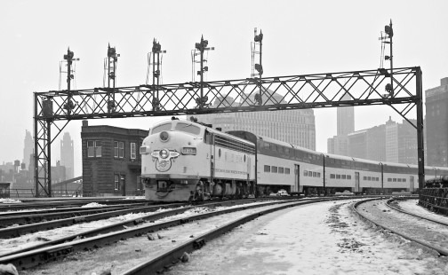 Signal bridge frames inbound Chicago and North Western passenger train of new cars in Chicago, Illinois, on March 9, 1960. Photograph by J. Parker Lamb, © 2015, Center for Railroad Photography and Art. Lamb-01-058-01