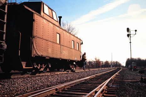 Caboose and crew member of northbound Ann Arbor Railroad freight train TF5 at Diann Tower in Dundee, Michigan, on February 1, 1975. Photograph by John F. Bjorklund, © 2015, Center for Railroad Photography and Art. Bjorklund-01-11-10