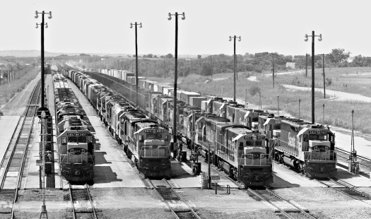 The Atchison, Topeka and Santa Fe Railway was a leader in developing unit trains, and quickly realized that such trains also needed run-thru yards, as no classification was needed. This southward view was recorded soon after the yard at Temple, Texas, was finished in mid-1985. The two outer tracks are occupied by southbound trains in the distance. Seen here are grain, grain, coal, and intermodal trainsl. It was also no accident that Temple was selected as the location, as this is the junction of midwest and western Santa Fe lines. Photograph by J. Parker Lamb, © 2016, Center for Railroad Photography and Art. Lamb-02-069-03