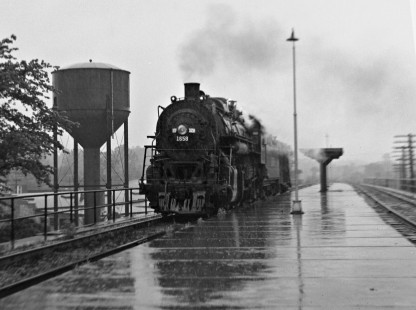 Summer shower overtakes an Illinois Central Railroad 2-8-2 steam locomotive and caboose in 1958 as they head south from Cairo, Illinois, into the Kentucky coal fields for a mine pickup. Photograph by J. Parker Lamb, © 2015, Center for Railroad Photography and Art. Lamb-01-027-04