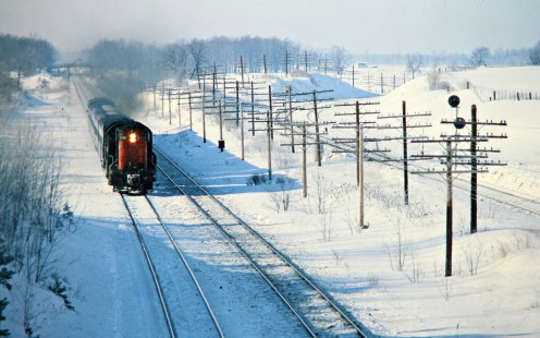 Eastbound Canadian National Railway passenger led by RS18 no. 3125 in Hyde Park, Ontario, on February 4, 1978. Photograph by John F. Bjorklund, © 2015, Center for Railroad Photography and Art. Bjorklund-20-17-06