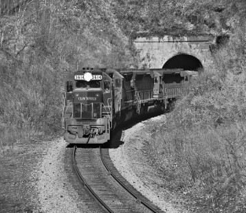 Southbound Clinchfield Railroad train exits Washburn tunnel no. 2, south of Spruce Pine, North Carolina, in October 1974. The view is from the portal of Washburn tunnel no. 3. Photograph by J. Parker Lamb, © 2016, Center for Railroad Photography and Art. Lamb-01-090-10