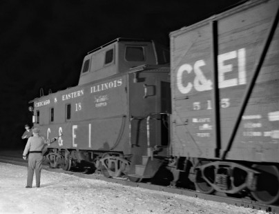 Chicago & Eastern Illinois Railroad operator handing up orders to the conductor of a southbound freight train at Glover tower, east of Urbana, Illinois, in December 1959. Photograph by J. Parker Lamb, © 2015, Center for Railroad Photography and Art. Lamb-01-042-01