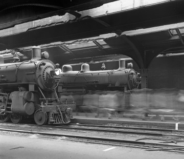 Commuters stream past Chicago & North Western 4-6-2 steam locomotives at the North Western Terminal in Chicago in the 1950s. Photograph by Wallace W. Abbey, © 2015, Center for Railroad Photography and Art. Abbey-02-066-02