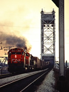 Eastbound Canadian National Railway freight train led by M636 no. 2314 crossing the St. Lawrence River in St. Lambert, Quebec, on April 26, 1980. Photograph by John F. Bjorklund, © 2015, Center for Railroad Photography and Art. Bjorklund-21-03-16