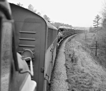 Rearward view of Seaboard Air Line Railroad train no. 75 near Moncure, North Carolina, as long string of autorack cars stretches to horizon; they were picked up at Norlina, NC, junction of Portsmouth, Virginia, line on October 21, 1961. Photograph by J. Parker Lamb, © 2016, Center for Railroad Photography and Art. Lamb-01-080-06