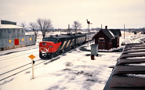 Eastbound Canadian National Railway passenger train led by FA-series diesel no. 6781 at station in Komoka, Ontario, on April 5, 1975. Photograph by John F. Bjorklund, © 2015, Center for Railroad Photography and Art. Bjorklund-20-03-18