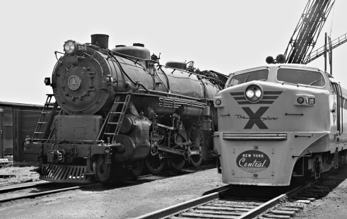 New York Central Railroad's modern <i>X-plorer</i> train rests next to a classic Baltimore & Ohio steam locomotive at the shop of Cincinnati Union Terminal, Ohio, in July 1956. Photograph by J. Parker Lamb, © 2015, Center for Railroad Photography and Art. Lamb-01-023-03