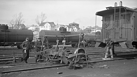 New York, New Haven and Hartford caboose no. C-521 on RIP track, being repaired by car men in Providence, Rhode Island, some time between 1950 and 1955. Photograph by Leo King, © 2016, Center for Railroad Photography and Art. King-01-088-004