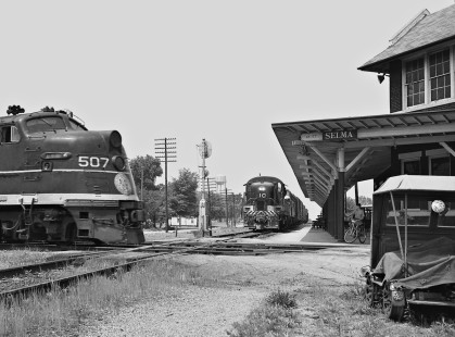 Eastbound Southern Railway local freight train waits for Atlantic Coast Line Railroad <i>Everglades</i> passenger train (no. 376) at station in Selma, North Carolina, in June 1962. (Note: boy and bicycle at station.) Photograph by J. Parker Lamb, © 2016, Center for Railroad Photography and Art. Lamb-01-083-03