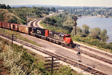 Eastbound Canadian National Railway freight train led by GP-series diesel no. 5551 in Hamilton, Ontario, on August 16, 1975. Photograph by John F. Bjorklund, © 2015, Center for Railroad Photography and Art. Bjorklund-20-08-10