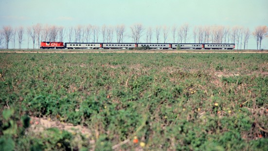 Westbound Canadian National Railway passenger train in Pointe-aux-Roches, Ontario, on October 12, 1975. Photograph by John F. Bjorklund, © 2015, Center for Railroad Photography and Art. Bjorklund-20-10-06