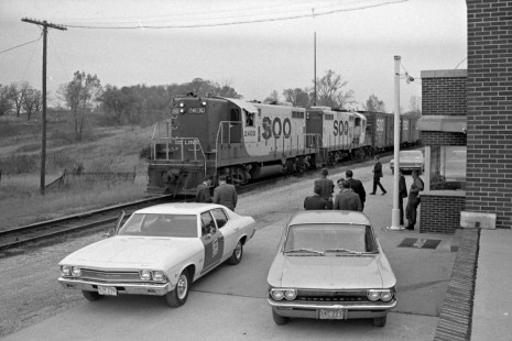 Soo Line officials watch a local freight train passing the depot at Roseport, Minnesota, just south of St. Paul, on October 14, 1968. This was the first day of Soo service to the refinery at Pine Bend. Photograph by Wallace W. Abbey, © 2015, Center for Railroad Photography and Art. Abbey-06-121-10