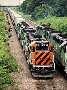 Eastbound and Westbound Burlington Northern Railroad freight trains in Aurora, Illinois, on July 15, 1989. Photograph by John F. Bjorklund, © 2015, Center for Railroad Photography and Art. Bjorklund-14-08-03