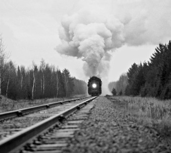 Westbound Duluth, Missabe and Iron Range Railway train heads north toward Hibbing, Minnesota, after passing Coleraine Junction, Minnesota, on April 24, 1960 (This was our final look at steam locomotive no. 229, who had put on a magnificent show for three guys from Illinois). Photograph by J. Parker Lamb, © 2015, Center for Railroad Photography and Art. Lamb-01-057-05