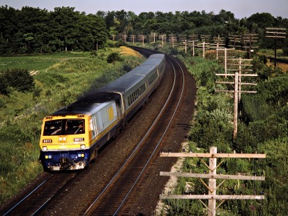 Eastbound VIA Rail passenger train on the Canadian National Railway in Hyde Park, Ontario, on July 4, 1986. Photograph by John F. Bjorklund, © 2015, Center for Railroad Photography and Art. Bjorklund-21-27-16