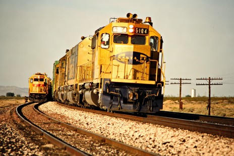 Westbound Santa Fe Railway freight train overtaking a slower westbound train in Goffs, California, on April 11, 1989. Photograph by John F. Bjorklund, © 2015, Center for Railroad Photography and Art. Bjorklund-05-17-06