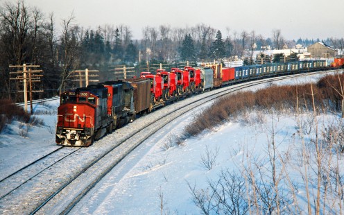 Westbound Canadian National Railway freight train led by GP40-2 no. 9658 in Hyde Park, Ontario, on February 4, 1978. Photograph by John F. Bjorklund, © 2015, Center for Railroad Photography and Art. Bjorklund-20-17-03