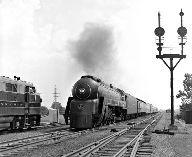 Northbound Baltimore and Ohio Railroad <i>Cincinnatian</i>, passenger train no. 54, meets southbound extra near yard office at North Dayton, Ohio, in August 1955. Photograph by J. Parker Lamb, © 2015, Center for Railroad Photography and Art. Lamb-01-002-11