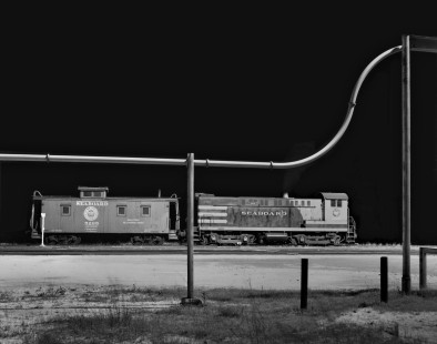 Seaboard Air Line Railroad switcher and caboose rest during break in evening work at Hamlet, North Carolina, hump yard in June 1961. Photograph by J. Parker Lamb, © 2016, Center for Railroad Photography and Art. Lamb-01-077-09