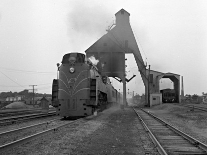 Chicago & North Western passenger train no. 2, the eastbound <i>Pacific Limited</i> with streamlined steam locomotive no. 4007, comes under the coaling tower at DeKalb, Illinois, on June 20, 1948. Photograph by Wallace W. Abbey, © 2015, Center for Railroad Photography and Art. Abbey-02-138-02