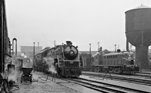 Summer shower bathes Canadian National Railway steam and diesel locomotives at Spadina roundhouse in Toronto, Ontario, on July 4, 1958. Photograph by J. Parker Lamb, © 2015, Center for Railroad Photography and Art. Lamb-01-052-06