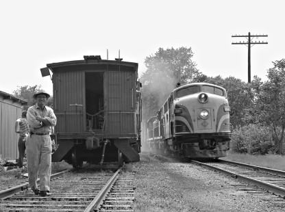 Eastbound Toledo, Peoria and Western Railway train passes work train at Washington, Illinois, in May 1959. Photograph by J. Parker Lamb, © 2015, Center for Railroad Photography and Art. Lamb-01-065-02