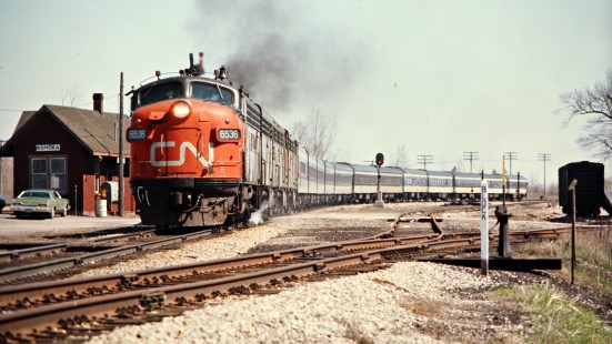 Westbound Canadian National Railway passenger train led by F-unit diesel locomotive no. 6536 at station in Komoka, Ontario, on April 19, 1974. Photograph by John F. Bjorklund, © 2015, Center for Railroad Photography and Art. Bjorklund-19-22-08
