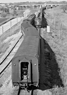 Long freight train causes northbound Missouri Pacific Railroad <i>Texas Eagle</i> passenger train into the siding at Round Rock, Texas, in May 1965. Photograph by J. Parker Lamb, © 2016, Center for Railroad Photography and Art. Lamb-02-059-02