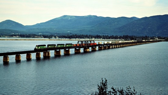 Westbound Burlington Northern Railroad freight train on Lake Pend Oreille in Sandpoint, Idaho, on July 10, 1983. Photograph by John F. Bjorklund, © 2015, Center for Railroad Photography and Art. Bjorklund-12-06-10