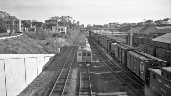 New York, New Haven and Hartford Budd Rail Diesel car heading down main line with caboose no. C-520 adjacent, in Providence, Rhode Island some time between 1950 and 1955. Photograph by Leo King, © 2016, Center for Railroad Photography and Art. King-01-031-002