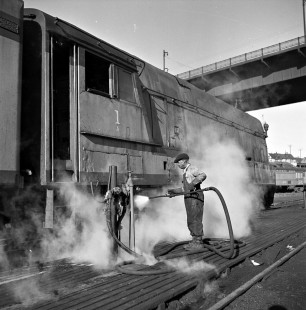 Chicago, Milwaukee, St. Paul & Pacific worker washing streamlined Class A 4-4-2 steam locomotive no. 1 at the railroad's Muskego Yard in Milwaukee, Wisconsin, on October 9, 1950. Photograph by Wallace W. Abbey, © 2015, Center for Railroad Photography and Art. Abbey-01-123-06