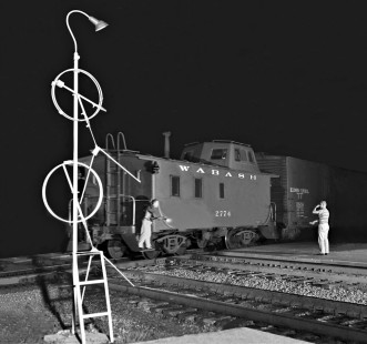 The operator at Tolono, Illinois, gives the "hotbox" signal to the conductor of an eastbound Wabash freight train on a July night in 1959. Photograph by J. Parker Lamb, © 2015, Center for Railroad Photography and Art. Lamb-01-038-01